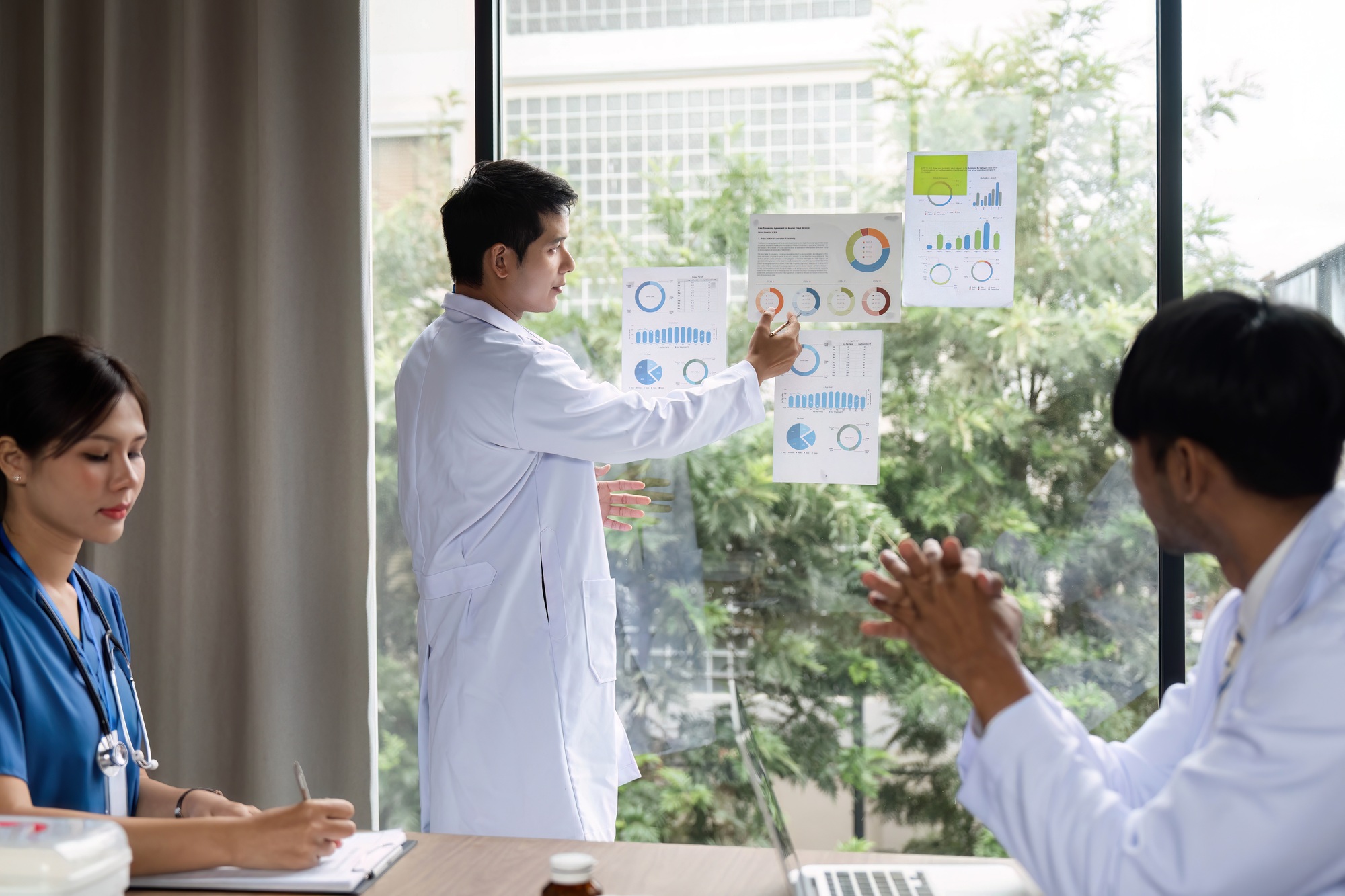 Doctor leading a meeting discussing patient data and outcomes